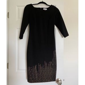 Short black dress with gold beads on the bottom